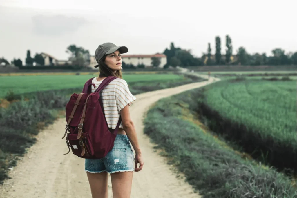 A woman walks alone in a South African vineyard